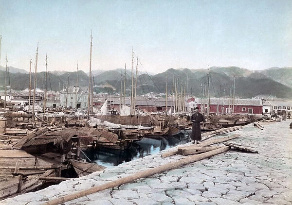 Boats tied up in Kobe harbour, Japan, circa 1890. Date: circa 1890
