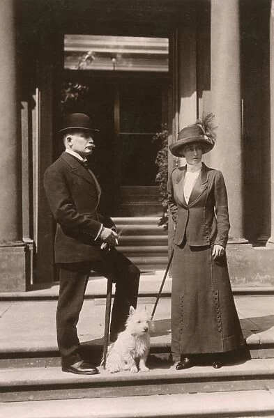 Edwardian couple with a white terrier dog on steps