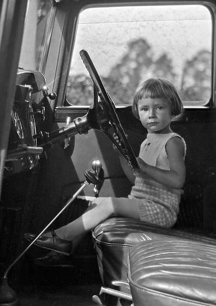 Little girl at the steering wheel