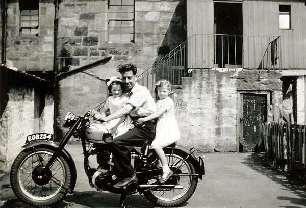 Man and two little girls on BSA Gold Star motorcycle
