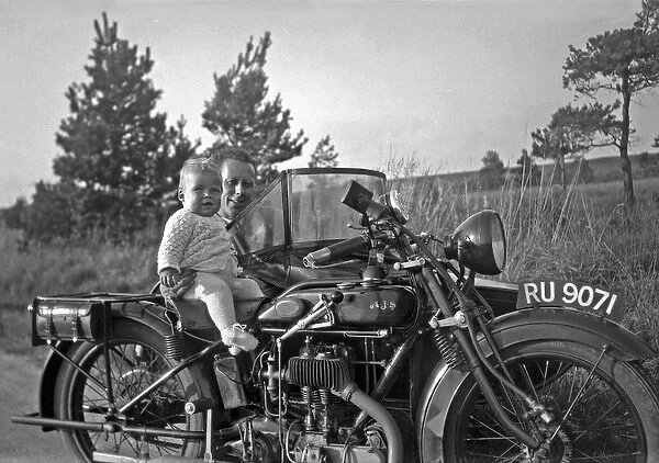 Man with motorbike and baby