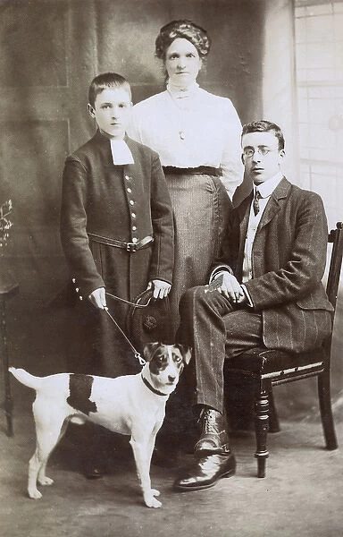 Three people with terrier dog