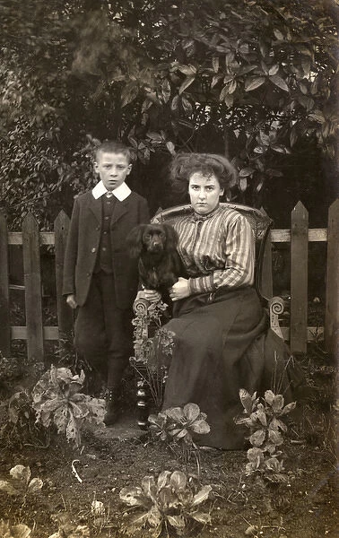 Woman and boy with dog in garden