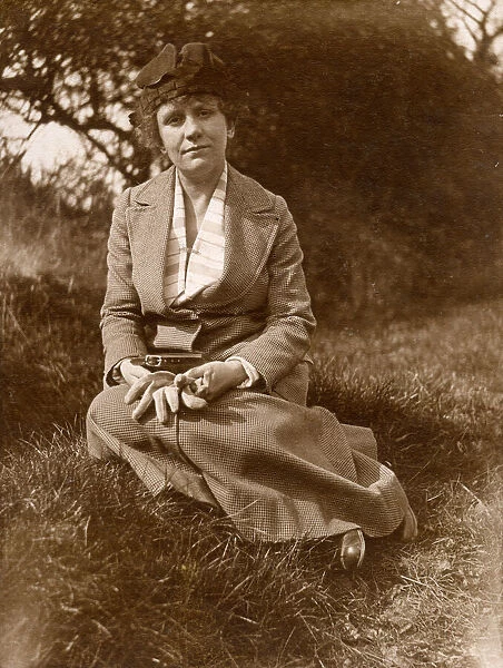 Woman sitting on grass in a field