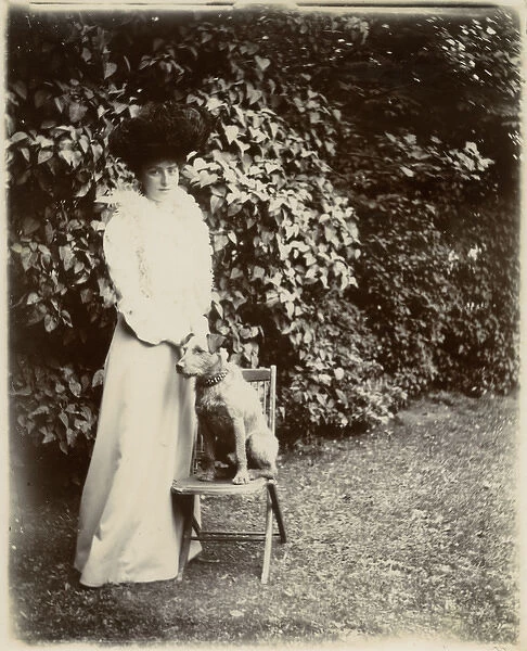 Woman with terrier dog in a garden