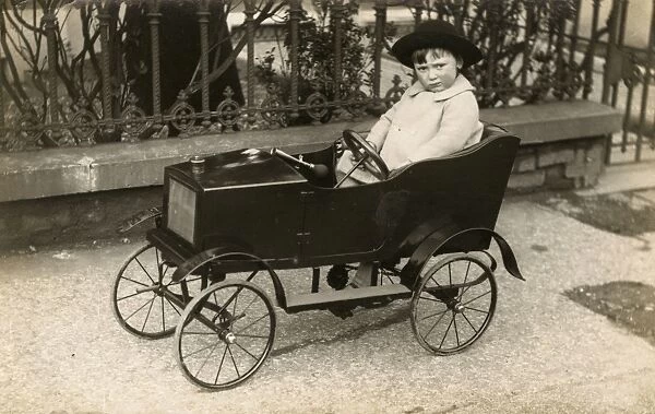 Young boy in his Rolls Royce style Toy Pedal Car