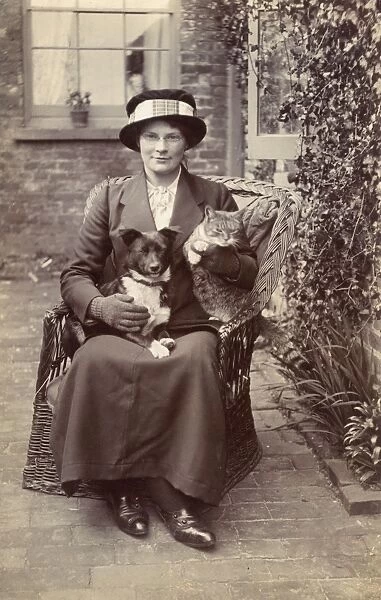 Young woman with dog and cat in garden