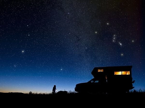Child and camper van under night sky