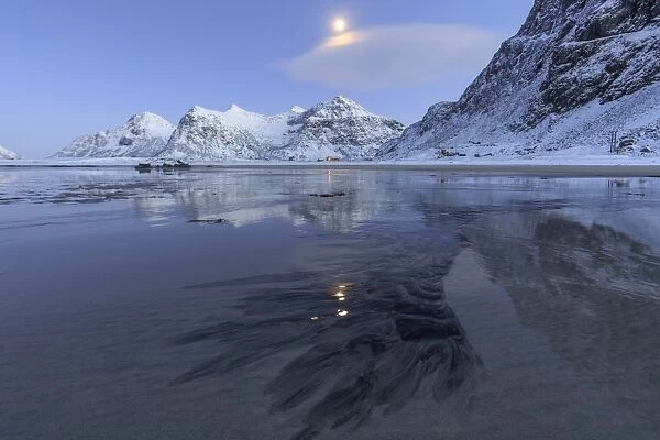 Full moon reflected in the icy sea around the surreal Skagsanden beach, Flakstad
