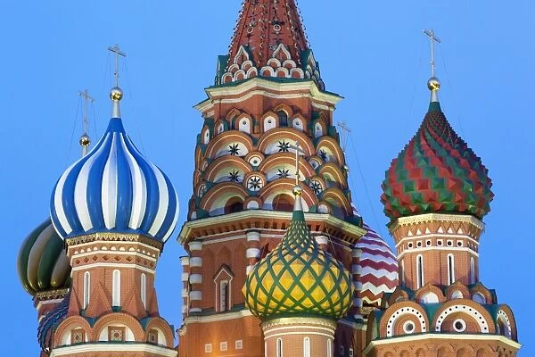 Onion domes of St. Basils Cathedral in Red Square illuminated in the evening, UNESCO World Heritage Site, Moscow, Russia, Europe