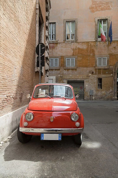 Small old Fiat 500 car parked on a back street in Rome, Lazio, Italy, Europe