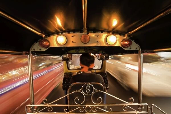 Tuk-tuk (auto rickshaw) in motion at night, Bangkok, Thailand, Southeast Asia, Asia