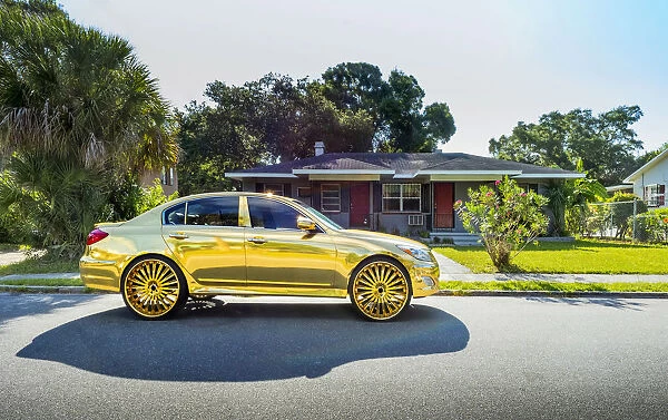 USA, Florida, Saint Petersburg, Big Wheel Custom Gold Car, African-American Neighborhood