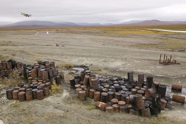 Abandoned barrels of leaking waste oil on the tundra at Nome in Alaska