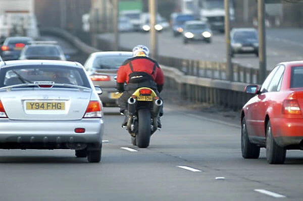 Motorcyclist in traffic current contemporary moving action motorbiker motorbike