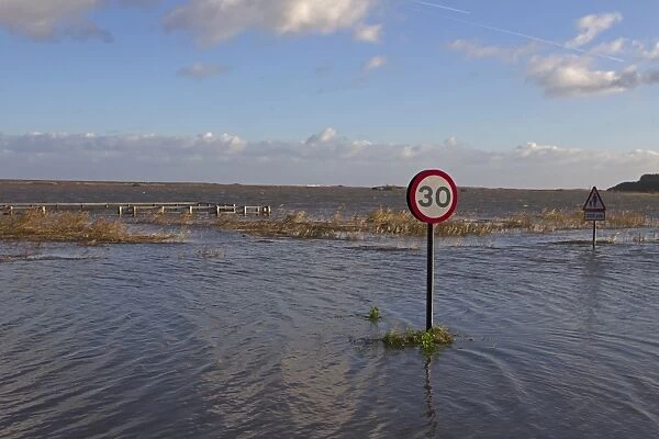 Flooded coast road and marshes after tidal surge, Cley-next-the-sea, North Norfolk, England, December 2013
