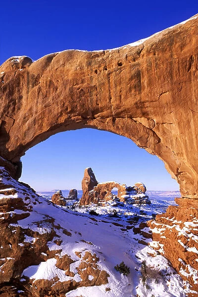 Morning light on North Window framing Turret Arch in winter, Arches National Park, Utah, USA
