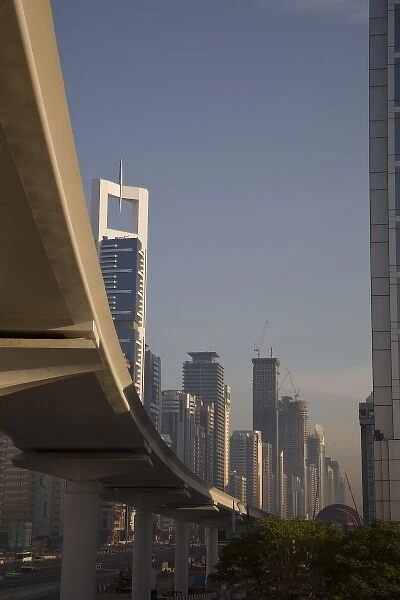 UAE, Dubai. Metro transit platform along Sheik Zayed Road, with Chelsea Tower in background
