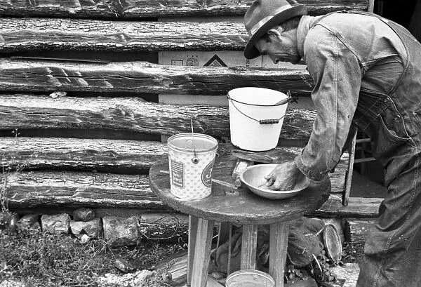 ARKANSAS: SHARECROPPER. A sharecropper washing his hands in a small water basin