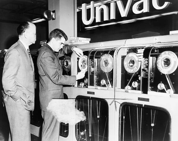 COMPUTER: UNIVAC, 1959. Man preparing a Univac computer to pick a winning horse