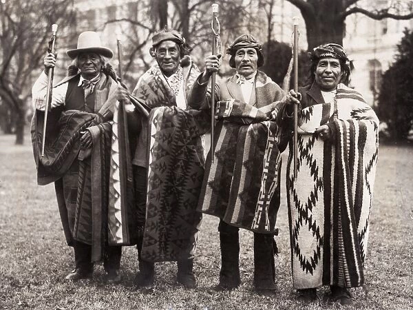PUEBLO MEN, 1923. Pueblo men, carrying blankets and canes given to them by Abraham Lincoln