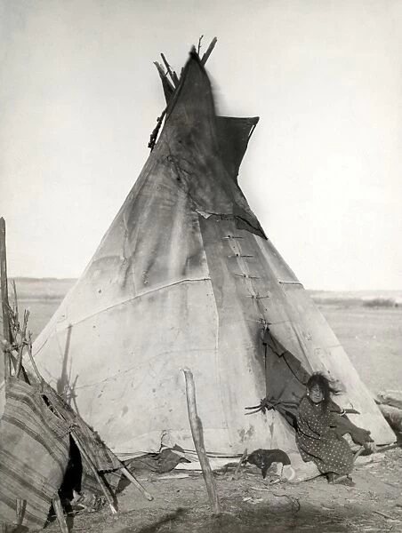 SIOUX TIPI, 1891. A young Oglala Sioux girl sitting in front of a tipi, with a puppy beside her, probably on or near the Pine Ridge Reservation in South Dakota. Photographed in 1891 by John C. H. Grabill