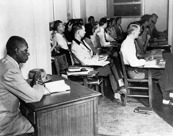 White students in class at the University of Oklahoma, while G. W. McLaurin, an African American student, is seated in the anteroom. Photograph, 1948