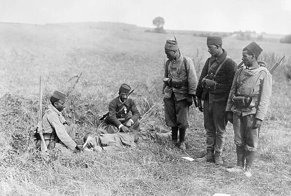 WWI: WOUNDED SOLDIER. French Moroccan soldiers caring for a wounded German soldier in France