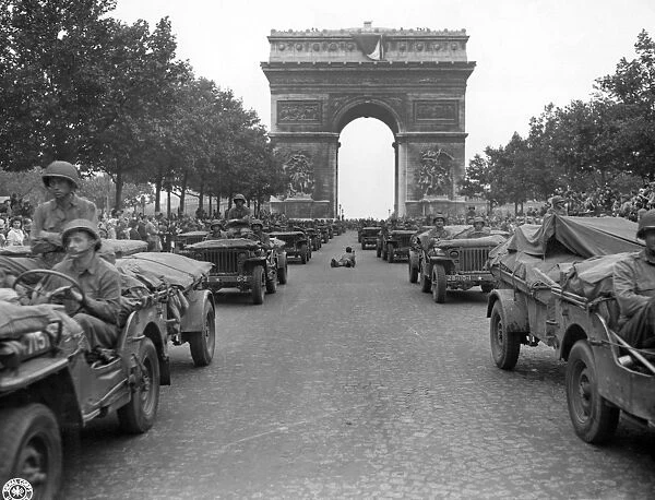 WWII: PARIS, 1944. American jeeps of the 28th Infantry Division driving down the