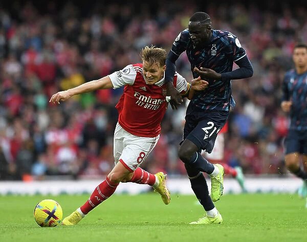 Arsenal vs. Nottingham Forest: Martin Odegaard Clashes with Cheikhou Kouyate in the 2022-23 Premier League