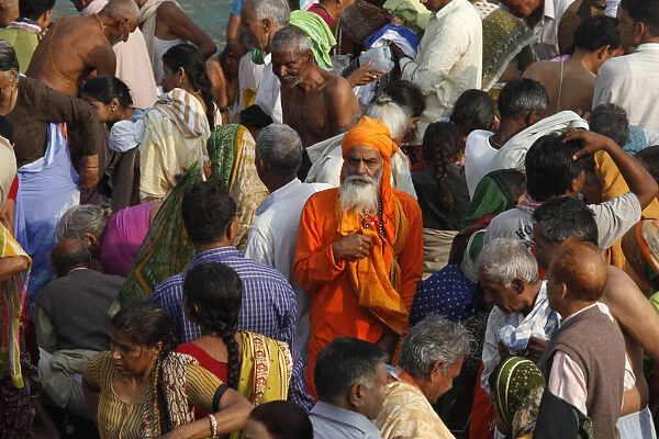 Devotees and holy men take a dip in the river Ganges during Navsamvatsar