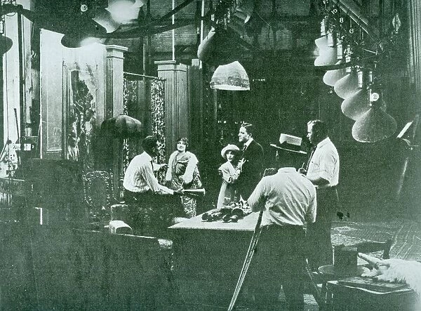 Director on set during the filming of a Silent era film. Circa 1918