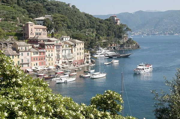 ITALY, Liguria, Portofino, waterside view of colourful houses & bay with boats