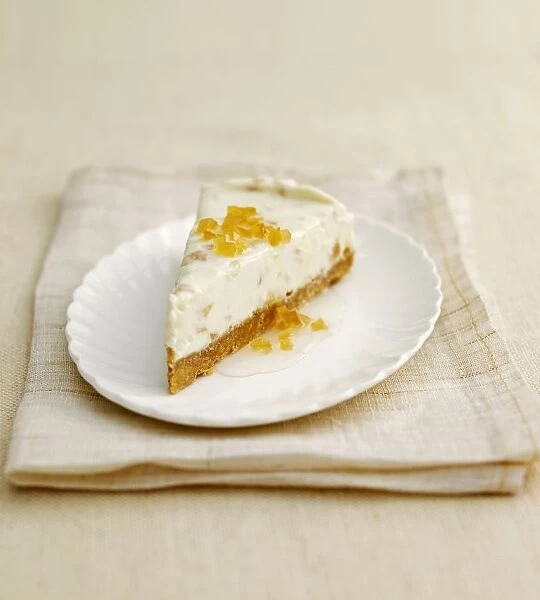 Slice of ginger cheesecake on white plate on folded napkin