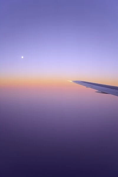 Full moon, plane wing, sunrise