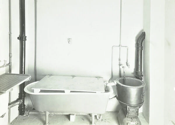 Dinmont Estate, Hackney Road: kitchen with bath and water pump, London, 1936 (b  /  w photo)