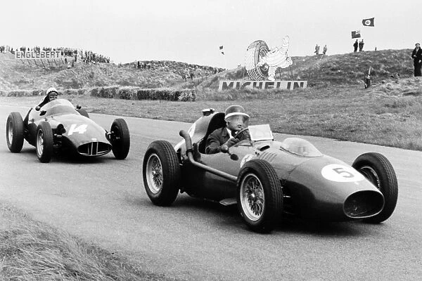 1958 Dutch Grand Prix: Mike Hawthorn, Ferrari Dino 246, 5th position, leads Jean Behra, BRM P25, 3rd position, action