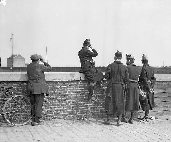 Belgian army officer observe the German advance from the outskirts of Louvain