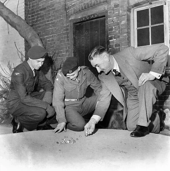 Bernard Wilcock Seen here playing marbles with a group of soldiers. March 1953 D1555
