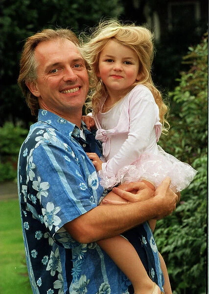 Comedian Rik Mayall with his youngest daughter Bonnie. 12th September 1998