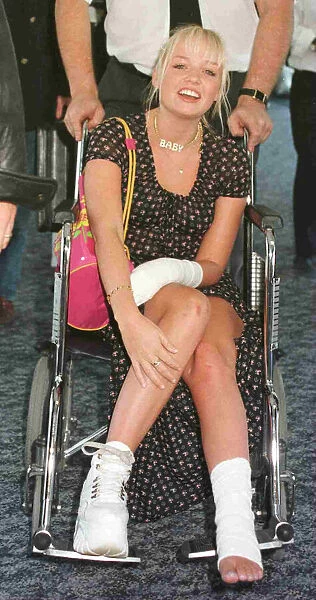 EMMA BUNTON BABY SPICE OF THE SPICE GIRLS RETURNS TO HEATHROW IN A WHEELCHAIR AFTER