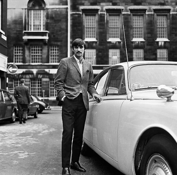 Manchester United footballer George Best beside his car. October 1967