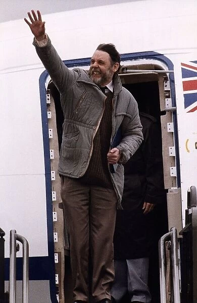 Terry Waite Waves his arm as he is about to get into the plane
