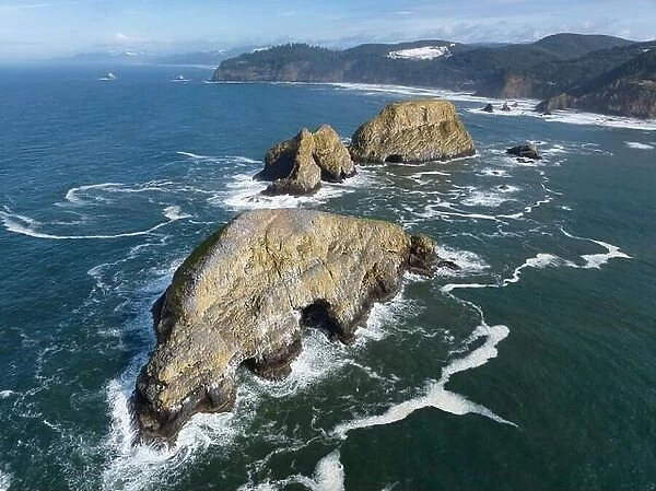 Sunlight shines on rugged sea stacks off the northern coast of Oregon, not far from Tillamook. This coastline has many outstanding viewpoints