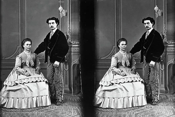 Stereoscopic photograph taken in studio, portraying a young couple in elegant nineteenth century dress