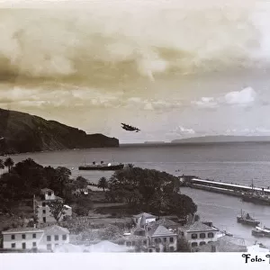 Coastal view of Funchal, Madeira with seaplane taking off