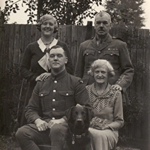 Family of four with a dog in a garden