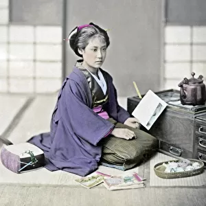Girl reading a letter beside a stove, Japan, circa 1880s. Date: circa 1880s