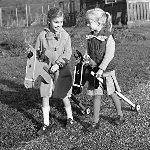 Two girls riding their hobby horses
