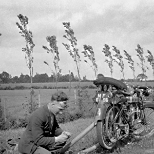 Man with motorbike in a field
